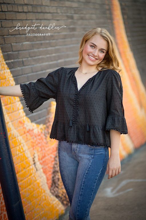 Senior portrait by the water at golden hour in the Austin Hill Country (vertical frame 48, variation 4)