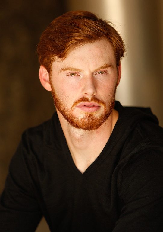 Actor headshot photographed outdoors in soft light in Austin, Texas (vertical frame 42, variation 6)