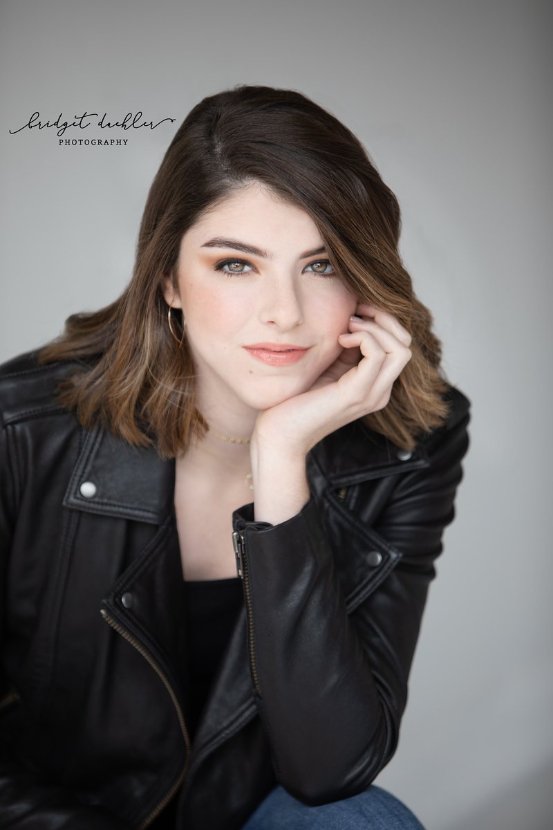 Downtown Austin senior portrait with soft urban light and natural posing (vertical frame 11)