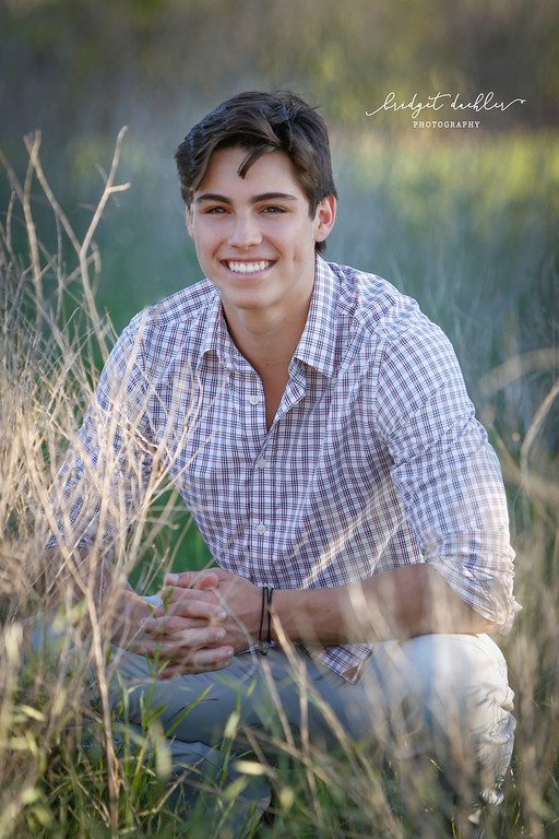 Senior portrait of a graduate posed against warm evening light in Austin, Texas (vertical frame 38, variation 4)