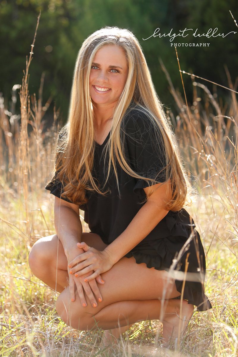 Senior portrait by the water at golden hour in the Austin Hill Country (vertical frame 12)