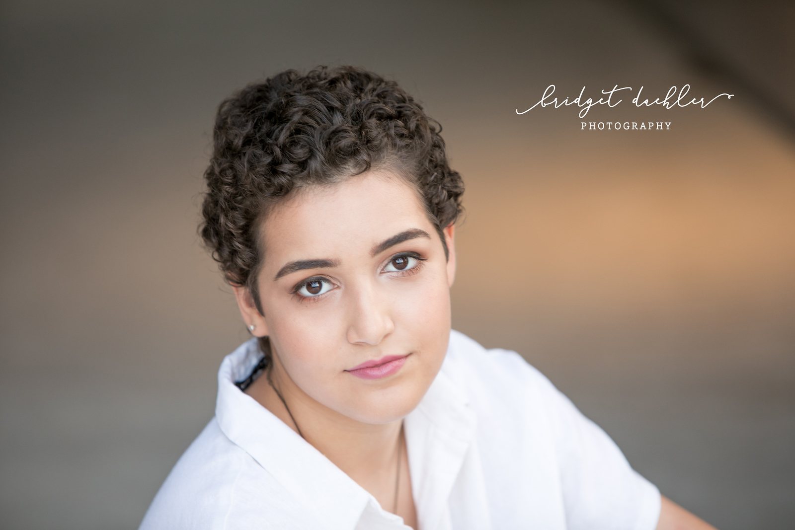 Outdoor senior session portrait framed by live oak trees in the Texas Hill Country (horizontal frame 15, variation 2)