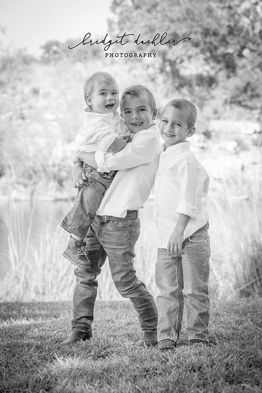 Family laughing together on a natural-light session in the Texas Hill Country (vertical frame 52, variation 6)