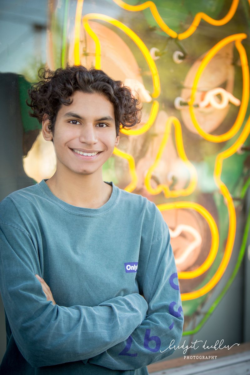 Close-up senior portrait with shallow depth of field, shot outdoors near Austin (vertical frame 30, variation 3)