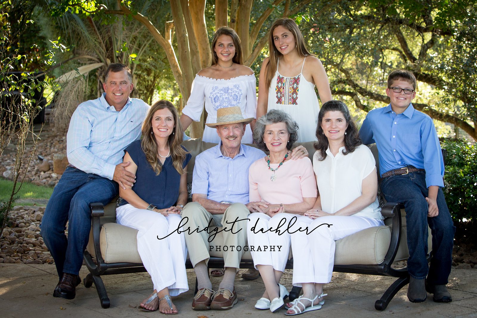 Family session portrait under live oaks at golden hour near Austin, Texas (horizontal frame 15, variation 2)