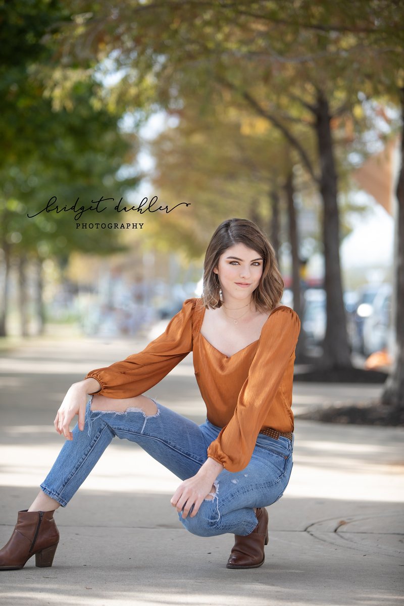 Full-length senior portrait on a quiet country road outside Austin, Texas (vertical frame 8)