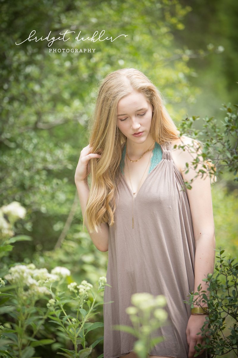 Full-length senior portrait on a quiet country road outside Austin, Texas (vertical frame 20, variation 2)