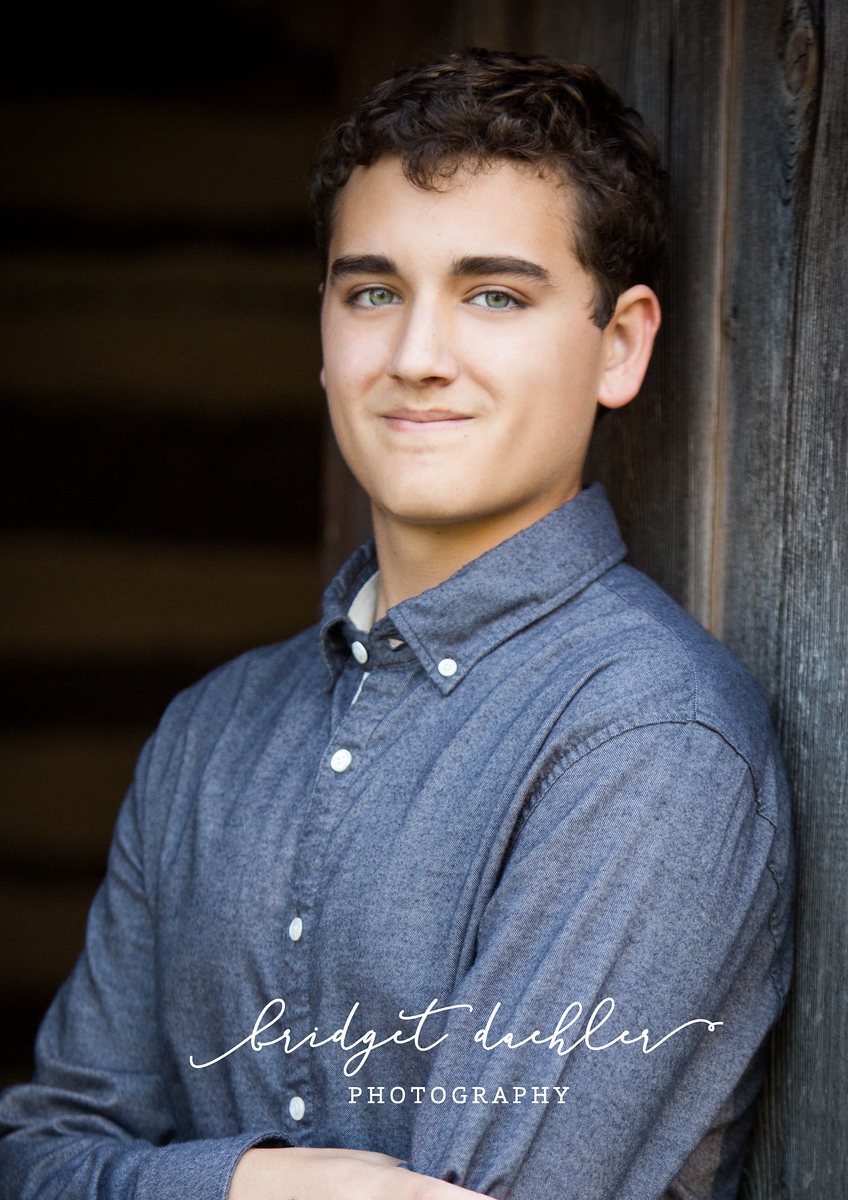 Senior portrait by the water at golden hour in the Austin Hill Country (vertical frame 24, variation 2)