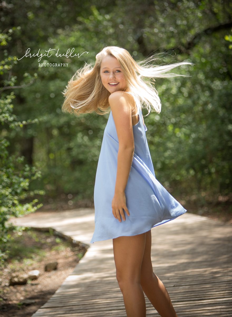 Golden-hour high school senior portrait taken in a Texas Hill Country field near Austin (vertical frame 25, variation 3)